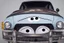 Placeholder: whimsical cartoon car with big eyes and its front grill forming a friendly smile