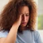 Placeholder: A woman who looks like she has just had a bad day. She is tired and stressed out. Her hair is frizzy and her eyes look as if they have seen better days. She is wearing a t-shirt and jeans.