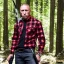 Placeholder: Georges st pierre with a red plaid shirt and a shotgun in the forest