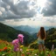 Placeholder: beautiful Green hills covered with flowers colorfull ,blue sky heavy clouds with godray ,very nice flowers at closeup ,wonderfull mountains at distance,beautiful lady clibming at hills full body shot