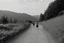 Placeholder: walking along a path that winds towards the top of a mountain, it is summer, photography taken with a Leica camera and 50mm lens, real photography in black and white, nostalgia