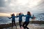 Placeholder: a group of Turkish young ladys in sports pants and blouse winter jacket are dancing in Babak Castle in Iran west north ,cloudy sun set sky,snowy environment