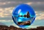 Placeholder: Blue transparent sphere seeing by a person, in the rocky alien landscape, infinite.