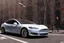 Placeholder: A Tesla 'Model S' is parked, near the 'Central Synagogue' in New York City. (CINEMATIC, WIDE ANGLE LENS, PHOTO REAL)