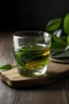 Placeholder: GREEN TEA LEAF AND GREEN TEA GLASS CUP IN WOODEN TABLE