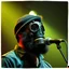 Placeholder: en skäggig man som försöker sjunga med en gasmask på en scen, gasmasker, dom kallar honom för babyface för att ser så barnslig ut