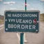 Placeholder: A road sign at the border between two nations