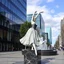 Placeholder: photo of a statue of ballerina made of black marbel in a modern city center