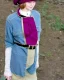 Placeholder: Everything she wear is in the image. of young woman, plum-blue-magenta-camouflage. She wears mantel and simple blouse.Felt cloth visor with tippet. SMALL FELT CAP is merged to Old AKG headphones with recognizable Golden rings! cloth materials are denim and felt cloth mixed. Fashion 1990's. Colors: Cream white, zinc plate, red ochre, ochre, orange - all mixed. Thick tights. Thick calves. She is in figure from top to toe.