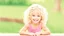 Placeholder: A cute little girl, curly blonde hair, the look on her smiling face.