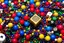 Placeholder: [dices and skills] close-up high res photo by Barry Webb: a gypsy's wrist surrounded and saturated by strings of beads, the hundreds of beads in every color shaped like dice or skulls. It's the childlike, mortal symbol of chance intertwined with destiny.