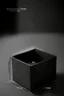 Placeholder: A mockup for a floating box with the measurements of 10 cm wide, 10 cm deep, 23 cm high , dark studio setting, black background