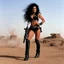 Placeholder: Julie Strain in action, standing on a dusty hill in the badlands - Heavy Metal F.A.K.K.2 her machine-gun in hand