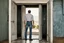 Placeholder: man in jeans and a shirt, back to the camera, standing in a row of doors, looking out through a doorway