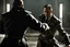 Placeholder: Action shot of Tom Hardy as Father Alexander Anderson from the live action "Hellsing" movie based on the anime of the same name. He is fighting Alucard (played by Tom Hiddleston).