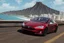 Placeholder: A Tesla 'Model 3' is racing at top speed, at the beach of Waikiki in Hawaii. CINEMATIC. WIDE ANGLE LENS. PHOTO REAL.