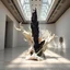 Placeholder: Ultra-detailed surreal biomorphic gallery sculpture of ivory organic forms contrasted with sharp obsidian crystal structures, displayed inside a high-end contemporary art museum with polished stone floors, massive white exhibition walls, skylight beams cutting through dust particles, dramatic spotlighting on the sculpture, cinematic depth, Octane render style, 8k