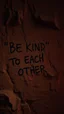 Placeholder: A hand writing On cave wall written “BE KIND “ “ TO EACH OTHER “ , an old man with bear and king hair wrote by the cave wall , a dim lighting great quality picture with primitive style