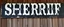 Placeholder: fill composition with large and wide hand painted old western sign that reads: "SHERRIF" white on black with inset white stripe aged paint