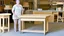 Placeholder: lady standing behind a unassembled table