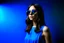 Placeholder: advertising photography, plain blue background, pop style photography, woman in blue dress, brunette, round sunglasses, real photography, 16K, shot with Leica camera, 35 mm lens, indirect lighting,