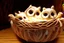 Placeholder: Cute stuffed owls lie in a carved basket on a soft sling, by candlelight