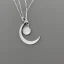 Placeholder: Clear polyester necklace with a silver pendant in the shape of a crescent moon