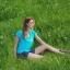 Placeholder: gorgeous young Swiss girl sitting standing in green field, mountain, sun, wearing blue shirt over, open arms, realistic eyes, unreal engine, photograph, realistic skin texture, photorealistic, hyper realism, highly detailed, 85mm portrait photography