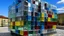 Placeholder: A CONSTRUCTION THAT MIXES HOLLOW CUBES WITH GLASS SPHERES INHABITED BY DIVERSE PEOPLE