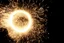 Placeholder: dark background. spinning circle of sparks (bottom and right)