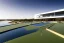 Placeholder: algarve in quinta do lago, one straight line building of 250 meters long pool of a modern luxury architecture with wood and gold metallic pergolas with pool on rooftop, overlooking a tennis and padel sport facility, on a slope with pinus pinea, a road wrap around for low speed veicular road