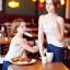 Placeholder: Realistic photo Russian shorthair beautiful 20-years tomboy boyish boylike young wife wide hips in restaurant with little daughter