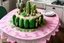 Placeholder: cacti birthday cake on lace tablecloth in a modern kitchen in sunshine