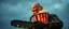 Placeholder: pop corn bucket that looks like a chain saw wielded by serious angry bald law man