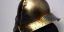 Placeholder: apocalypse, chaotic, magnificent, realistic, colorful, massive, epic, ray tracing, cinematic, 8k, HD, Ultra High Definition, photo film, film grain, hyper-detailed, old tarnished ornate rusty Hyper detailed Gold Gothic Medieval Knight helmet with glass visor covering face and matching whole body suit of armor, realistic proportions, no face