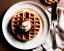 Placeholder: Round waffle with maple syrup plate, plaid napkin and fork