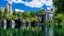 Placeholder: small gothic house built into a rock, lake, trees, arches, bridge, foliage, balconies, verandas, blue sky, white clouds