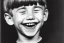 Placeholder: Photo of a bUck-toothed boy with a Huge grin and Bowlcut, closed eyes