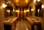 Placeholder: Pictures of a group of bathrooms in Mathaf Restaurant. The walls and floors are colored in brown tones