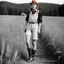 Placeholder: [photo by Helmut Newton] Grown up Pippi Longstocking: with a revealing overalls and cowboy boots in a field