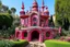 Placeholder: A pink and magenta castle with a garden designed in African pottery painted by Jean Dubuffet