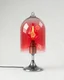 Placeholder: a lamp on a metal base under a glass dome in the form of a glass, inside a lamp of unusual shape