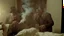 Placeholder: men smoking many cigars fill hotel room with waxy film