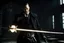Placeholder: Still frame of Tom Hardy as Father Alexander Anderson from the live action "Hellsing" movie based on the anime of the same name. He is throwing glowing swords.