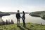 Placeholder: An image of two people exchanging criticism in a constructive and respectful manner, standing on a hill with a lake behind them