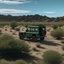 Placeholder: A flat area of ​​land with desert plants showing a dark green Land Rover