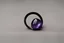 Placeholder: небольшое чёрное кольцо с лиловым камнем выпало на пол.