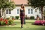 Placeholder: very beautiful lady with beautiful midi dark black-red lace skirt and lace top with curvy hair sports shoes standing in a nice villa yard with trees flowers ,16 by 9