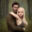 Placeholder: A photo realistic portrait of a stunning blonde girl and a handsome muscular dark haired man in a lovers embrace standing in a forrest