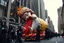 Placeholder: macys thanksgiving day parade style cartoonish giant baby jesus floating parade balloon pulled by multiple grim reapers, multi colored, bright, vivid, psychedelic, high detailed, high gloss, insanely detailed, matte, horrorcore, lining the street, unsettling contrast, monument to death, live action shot grim reaper parade, pulling a jesus parade float